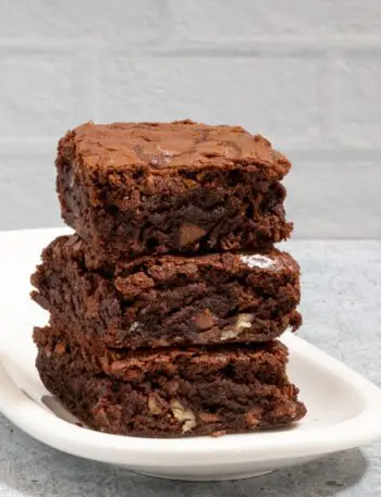 fudgy brownies stacked on a small plate