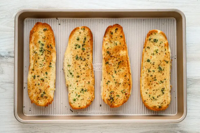 Homemade garlic bread on sub rolls, perfectly browned.