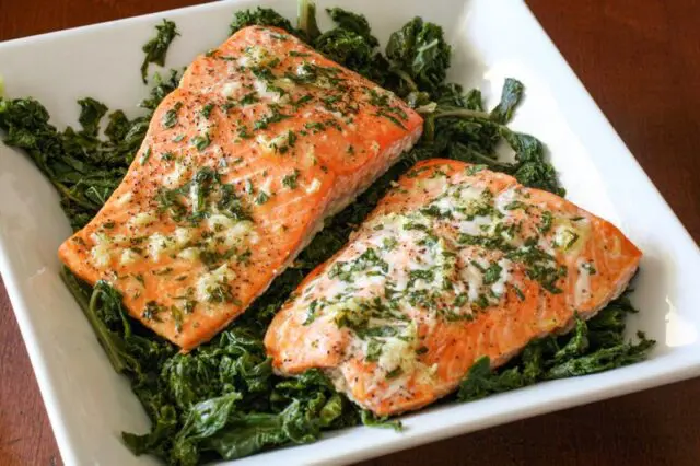 garlic and herb salmon on a bed of spinach