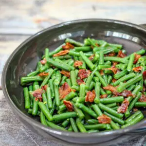 A DFW stoneware plate with southern-style green beans and bacon