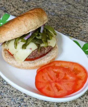 chile pepper burgers with sliced tomatoes on a plate