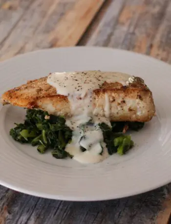 a halibut fillet on spinach