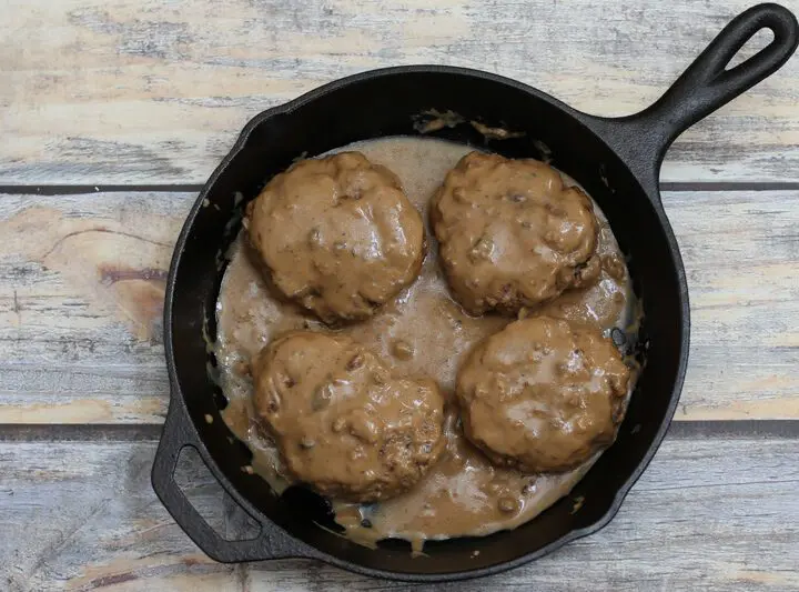 Overhead photo of hamburger steaks with gravy.