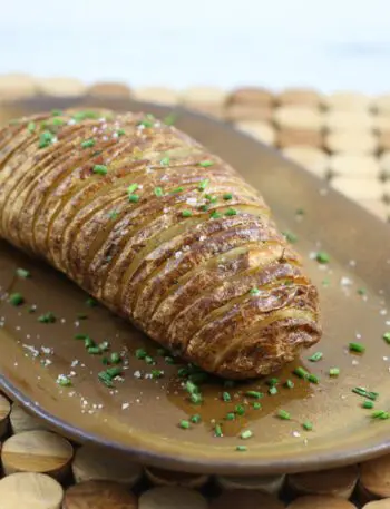 A baked hasselback potato on a plate