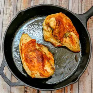 herb and butter roasted chicken breasts in a cast iron pan