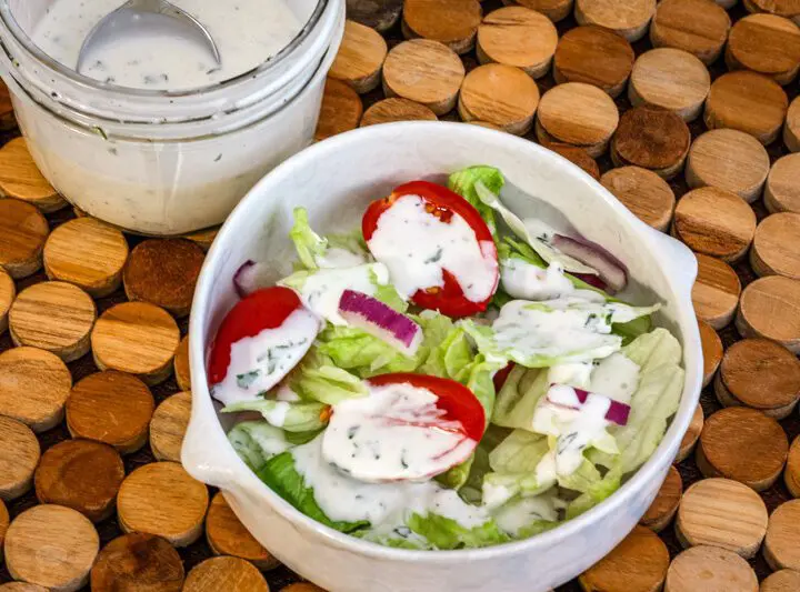 homemade buttermilk dressing drizzled on a tossed salad