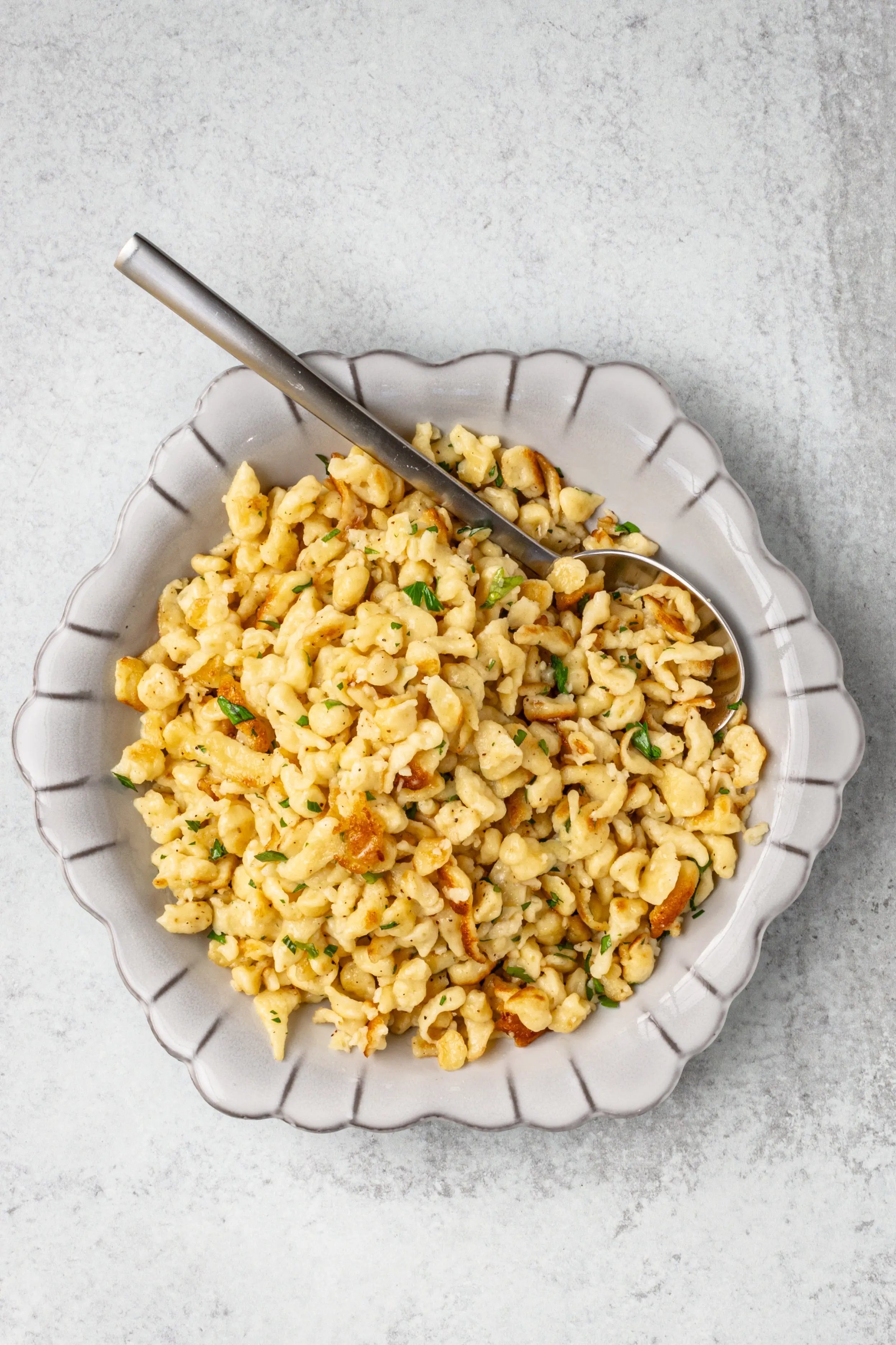 A plate of homemade spaetzle sautéed with butter.