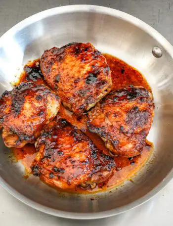 glazed honey garlic chicken thighs in a skillet