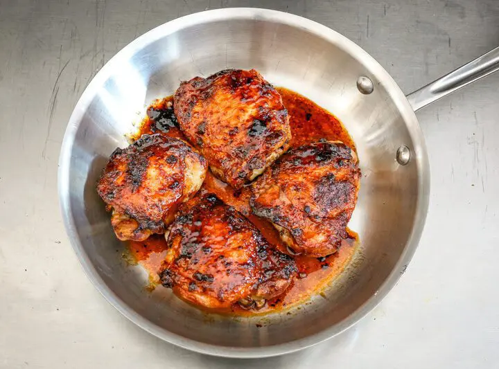 glazed honey garlic chicken thighs in a skillet