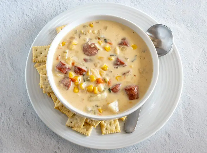 hot dog chowder in a bowl with mini saltine crackers on the side