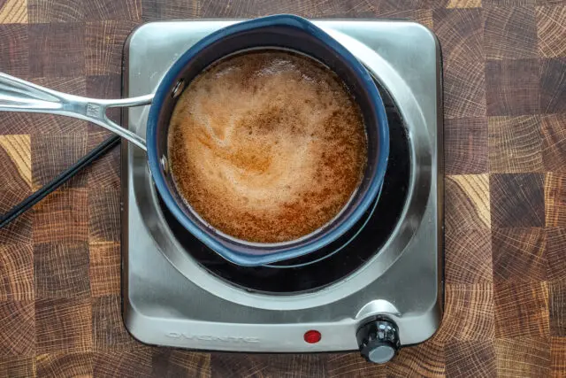 Sauce for hot honey chicken wings made with butter and hot sauce, and also some lime zest.