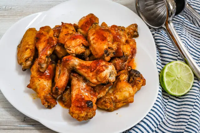 Hot honey chicken wings coated with the hot sauce mixture and drizzled with lime juice.