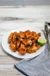 Hot honey chicken wings preparation with hot sauce, butter, honey, lime zest and juice, garlic powder, and onion powder.