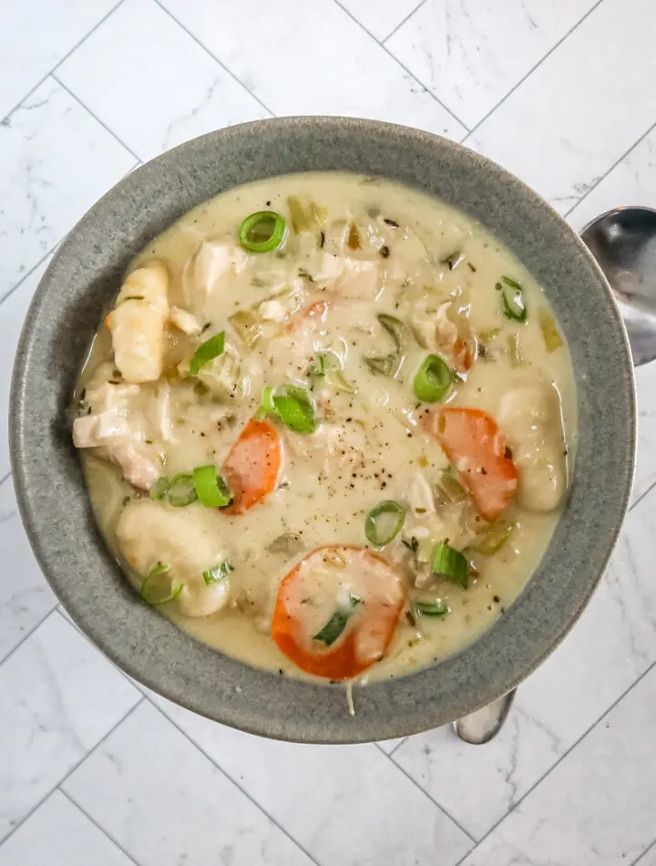 Chicken and dumpling soup with gnocchi dumplings, vegetables, and a creamy chicken broth.