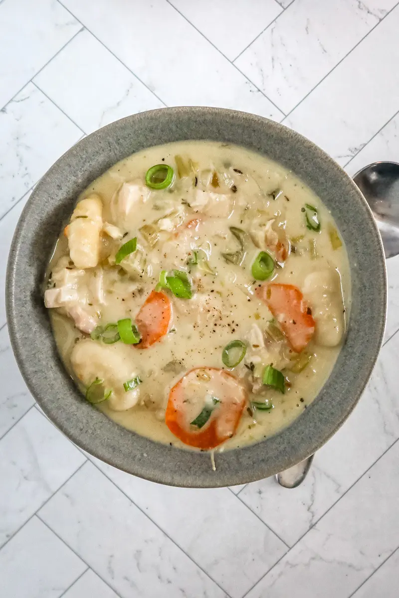 Chicken and dumpling soup with gnocchi dumplings, vegetables, and a creamy chicken broth.