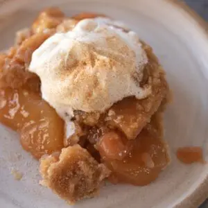 instant pot apple dump cake with whipped cream and cinnamon sugar