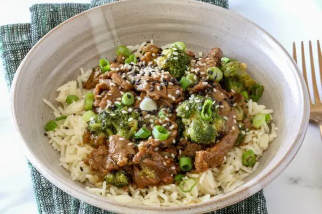 instant pot beef and broccoli in a bowl on rice