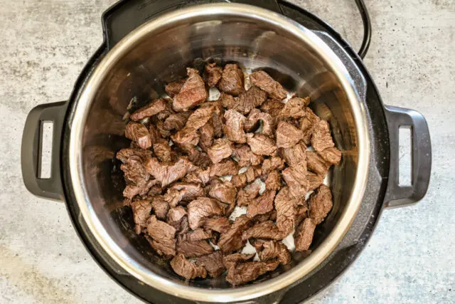 Sautéing the beef for Instant Pot beef stroganoff.