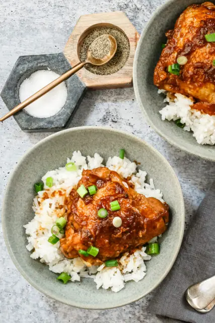 Overhead shot of Instant Pot chicken adobo with scallion garnish and shown on rice.