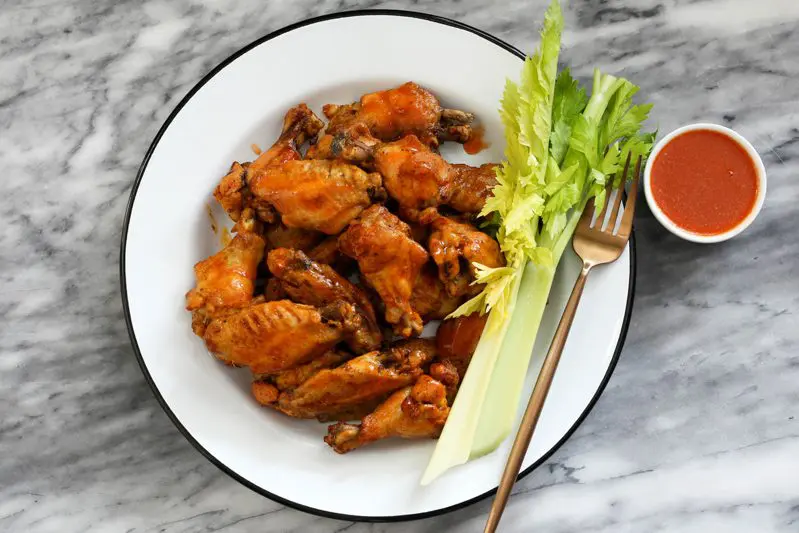 instant pot chicken wings with dipping sauce and celery on a plate