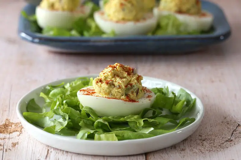 a deviled egg cooked in the instant pot on a bed of lettuce