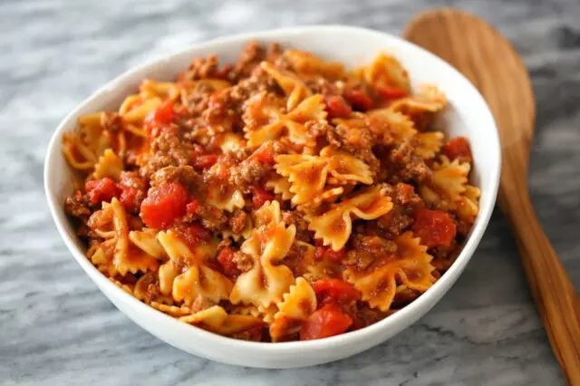 instant pot beef and farfalle in a serving bowl