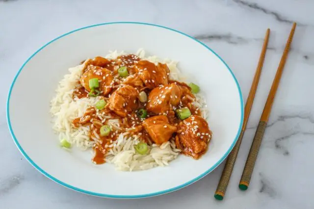 Instant Pot General Tso's chicken with sesame seeds over rice