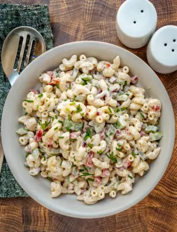 Instant Pot macaroni salad in a serving bowl with chives for garnish.