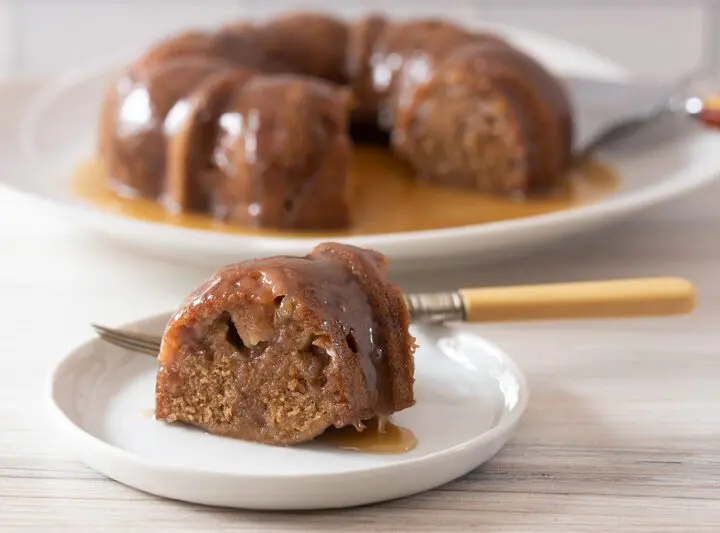 instant pot pear cake, sliced with the whole cake in the background