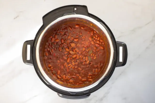 Stir the tomato paste into the beans.