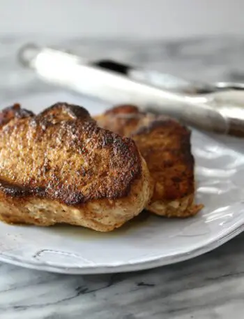 instant pot pork chops on a plate with tongs in the background