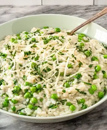 a serving dish with risotto and parmesan cheese