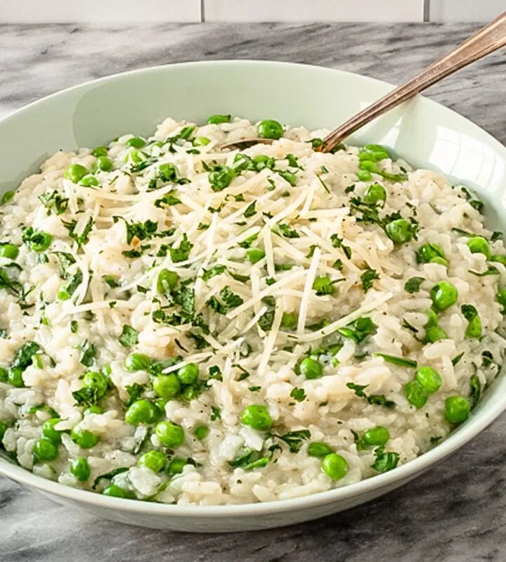 a serving dish with risotto and parmesan cheese