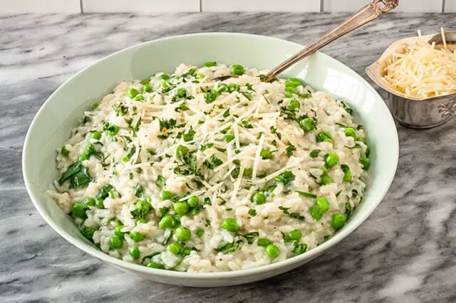 a serving dish with risotto and parmesan cheese