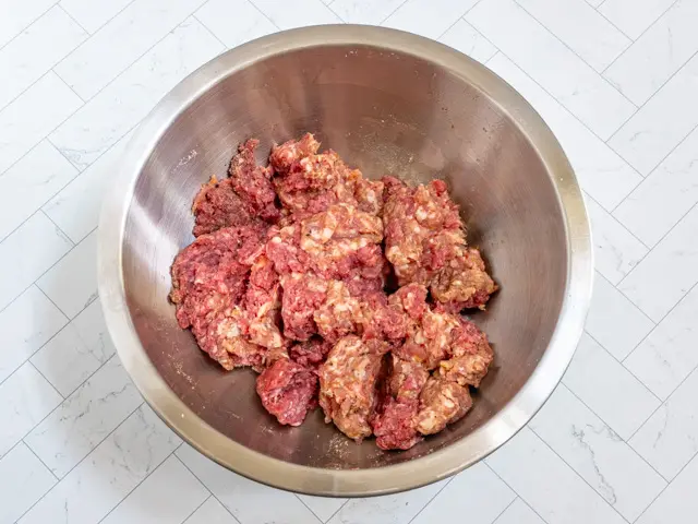 Prep the meat for meatballs.