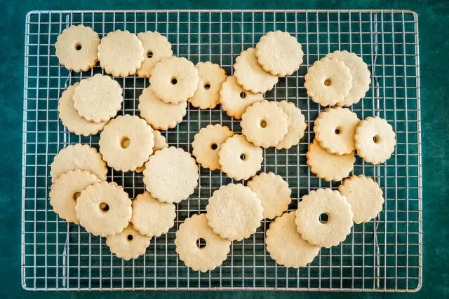 Baked jammie dodgers cookies on a cooling rack.