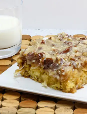 a slice of Cajun cake on a plate with a glass of milk