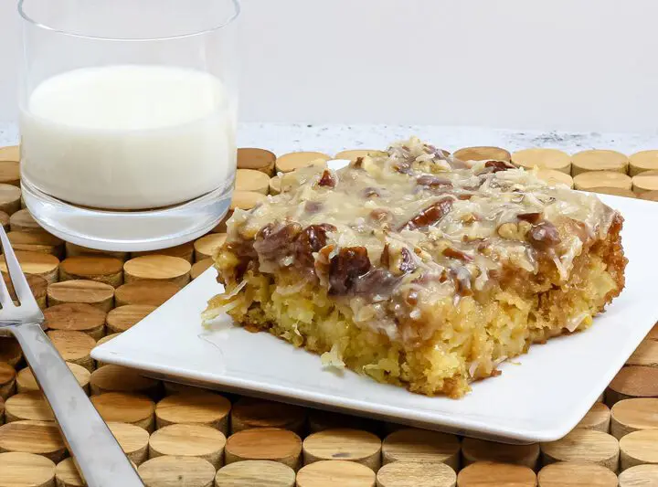 a slice of Cajun cake on a plate with a glass of milk