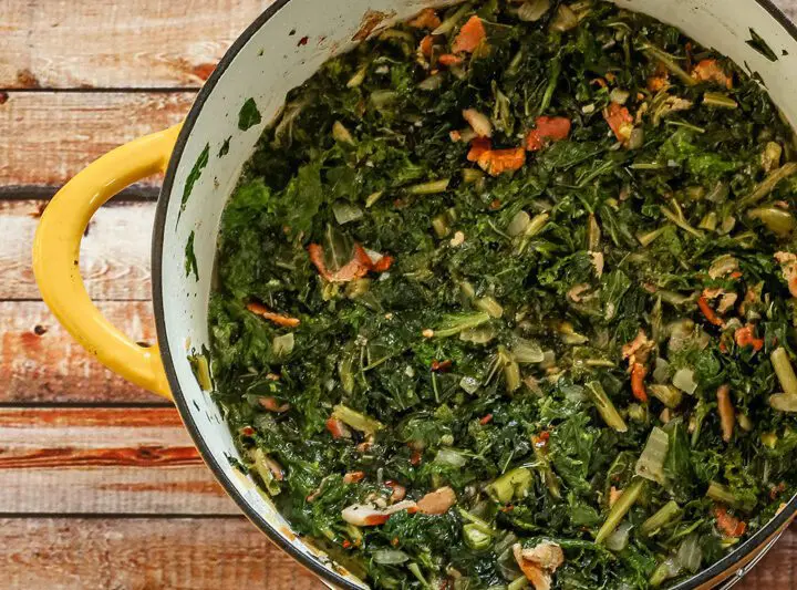 dutch oven with a mess of kale and mustard greens with bacon