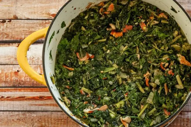 dutch oven with a mess of kale and mustard greens with bacon