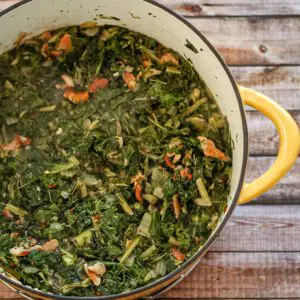 greens and bacon in a dutch oven