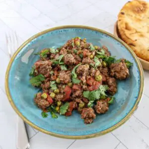 a serving of kheema matar, spiced ground beef with peas and tomatoes