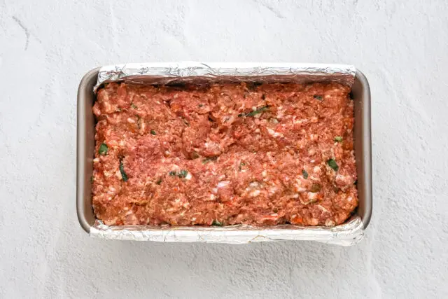 Korean meatloaf ingredients are combined and added to the loaf pan, ready to bake.