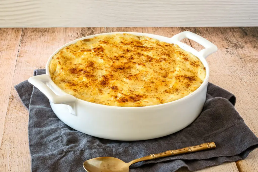 Baking dish with a casserole topped with mashed potatoes