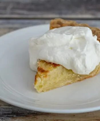 a lemon buttermilk pie with whipped cream
