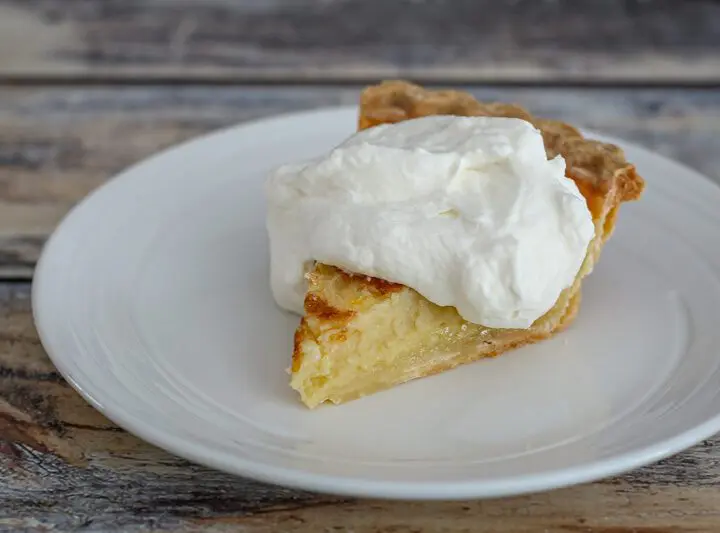 a lemon buttermilk pie with whipped cream