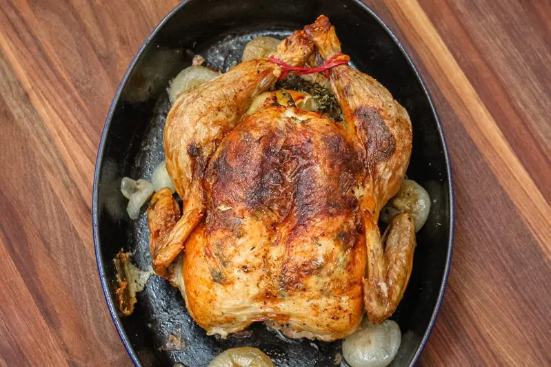 lemon and herb roasted chicken in a baking pan
