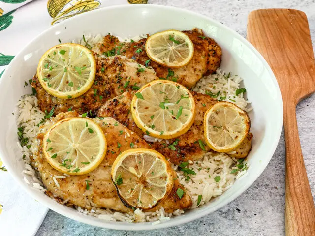 Lemon pepper chicken on a bed of rice.