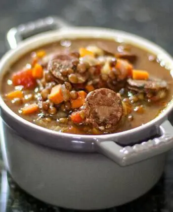 lentil and sausage soup in a small bowl