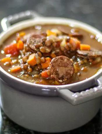 lentil and sausage soup in a small bowl